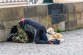 Prague, Czech republic - March 19, 2020. Beggar man with dogs begging on Charles Bridge without tourists during coronavirus crisis