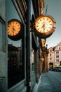 Prague, Czech Republic, March 9, 2022: Big luminous clock on The Old Town Square is reflecting on glass case, evening