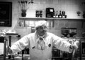 Prague, Czech Republic - March 13, 2017: Elderly pastry chef at the counter cafe Black and white image