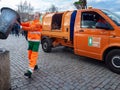 The garbage collector is pouring garbage into the garbage truck