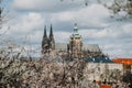 Prague, Czech Republic, 26 March 2023: Panorama of old town from Petrin Hill, Red roofs, Cloudy spring day, High spires medieval