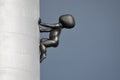 Prague, Czech Republic - May 17 2022: Sculpture of a bronze faceless baby crawling the Zizkov TV Tower. Designed by
