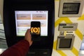Prague, Czech Republic - May 18th 2019: Bitcoin ATM machine for buying and selling cryptocurrency. Male sells Bitcoin Cash by ATM