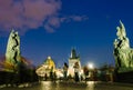 Tourists strolling and take photographs on the Charles bridge at