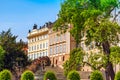 Spring cityscape of Prague with beautiful architecture, green trees and blue sky