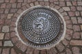 Street manhole cover on the paving stones in Prague, Czech Republic