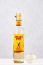 Prague, Czech republic - October 19, 2019. Bottle of Gusano Rojo Mezcal with shot on light background