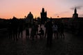 A group of photographers shoots the dawn on the Charles Bridge. Tourists take pictures