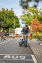 Prague, Czech republic - October 10, 2023: Happy family father teaches child daughter to ride public bike on one of