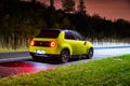 Prague, Czech republic - October 26, 2020. Night photo of electric Honda e on the road after rain