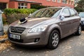 Brownish Kia Cee`d decorated for a wedding parked on a street in autumn