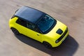 Prague, Czech republic - October 02, 2020. Yellow green electric Honda E in move - view to the rooftop