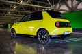 Prague, Czech republic - October 02, 2020. Yellow green electric Honda E parked in industrial parking spot - back view