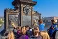 PRAGUE, CZECH REPUBLIC - OKTOBER 10, 2018: Tourists rub metal statue as a tradition for wishing on a bridge in Prague