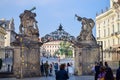 PRAGUE, CZECH REPUBLIC - OKTOBER 10, 2018: Tourists under the gate with sculptures in Prague