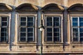 Prague, Czech republic - September 19, 2020. Architectonic details of building in Pohorelec street - old windows with street lamp Royalty Free Stock Photo