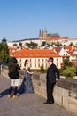 Asian couple pose for wedding portratis on Charles Bridge over Vltavar River in Prague, Czech Republic
