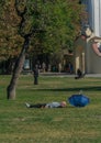 Prague, Czech Republic - September 10, 2019: bold Man sleeps on the grass in a sunny day at kampa park