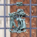 Prague, Czech Republic - September 23, 2019. A copper bas-relief on the fence of St. Vitus Cathedral depicting rural life Royalty Free Stock Photo