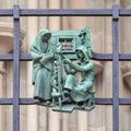 Prague, Czech Republic - September 23, 2019. A copper bas-relief on the fence of St. Vitus Cathedral depicting rural life Royalty Free Stock Photo