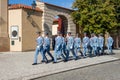 Men in blue military uniform marching outside Prague Castle PraÃÂ¾skÃÂ½ hrad on a hot Summer day Royalty Free Stock Photo