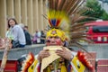 Native South American musician performing song with pan flute and wearing colorful costume in street of Prague
