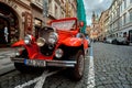 Prague, Czech Republic, September 15, 2017: touristic vintage classic red hot rod car on a cobble road Royalty Free Stock Photo