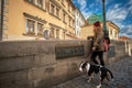 Prague, Czech Republic, September 15, 2017: Young women tourist with a puppy dog and a backpack Royalty Free Stock Photo