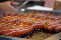 Prague, Czech Republic 2019:Traditional hot dog preparation on coal fire on the street during the Christmas market Royalty Free Stock Photo