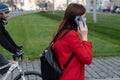 11/16/2020. Prague. Czech Republic. A woman wearing a mask is speaking on her phone while crossing the railways at Hradcanska tram