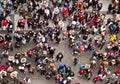 The crowd of people on the square in the center of Praque. People make photos of sight, view from above