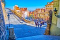 Tourists walk along the descent leadoing to Prague Castle from lower Mala Strana district in Prague, Czechia Royalty Free Stock Photo