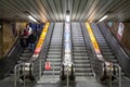 Commuters going down an escalator stairs rushing in the Prague Metro Prazske Metro. Royalty Free Stock Photo