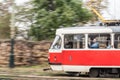 Pan shot of a Prague tram, Tatra T3 model, passing with a speed blur of an old town street. Managed by DPP