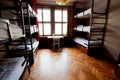 Small empty bedroom with bunk beds inside a hostel for youth, students and tourists Royalty Free Stock Photo