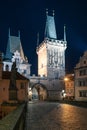 Prague, Czechia - 02.17.2022: View of Mala Strana Bridge Towers from Charles Bridge in the dark night. Prague center