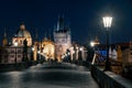 Prague, Czechia - 02.17.2022: View of Old Town Bridge Tower from Charles Bridge in the dark night. Prague center without