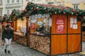 Prague, December 13, 2016: Christmas market in the main square. The woman looks with amazement and joy at the decorated