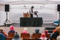 Prague, December 18, 2016: Design market in Prague - man in hat and suit shows puppet theater on street stage in front Royalty Free Stock Photo