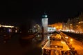 Prague at night, boat on the dock of the Vltava river, reflection of lights