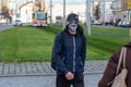 11/16/2020. Prague. 11/16/2020. Prague. Czech Republic. A man wearing a mask is crossing the railways at Hradcanska tram stop