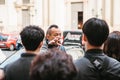 Prague, September 21, 2017: Asian guide emotionally tells Asian tourists about the sights of the city and interesting