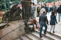 Prague, September 18, 2017: Tired man and woman or tourists sit on the stairs and relax. Other people are engaged in