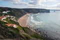 Praia da Arrifana beach with surfers on the atlantic ocean Royalty Free Stock Photo