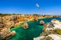 Praia da Marinha, beautiful beach Marinha in Algarve, Portugal. Navy Beach Praia da Marinha with flying seagulls over the beach Royalty Free Stock Photo