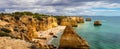 Praia da Marinha, beautiful beach Marinha in Algarve, Portugal. Navy Beach (Praia da Marinha) with flying seagulls Royalty Free Stock Photo