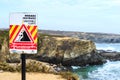 Praia dos Buizinhos, warning for unstable cliffs,, Portugal