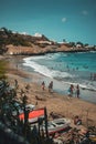 'Kebra Canela' beach. One of the main beaches of Santiago, with people on it and boats on the side.