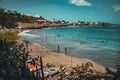 'Kebra Canela' beach. One of the main beaches of Santiago, with people on it and boats on the side.