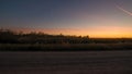 Prairie grassland and rural rustic gravel road landscape at sunset with orange, yellows, and blues in sky - at the Crex Meadows Wi Royalty Free Stock Photo